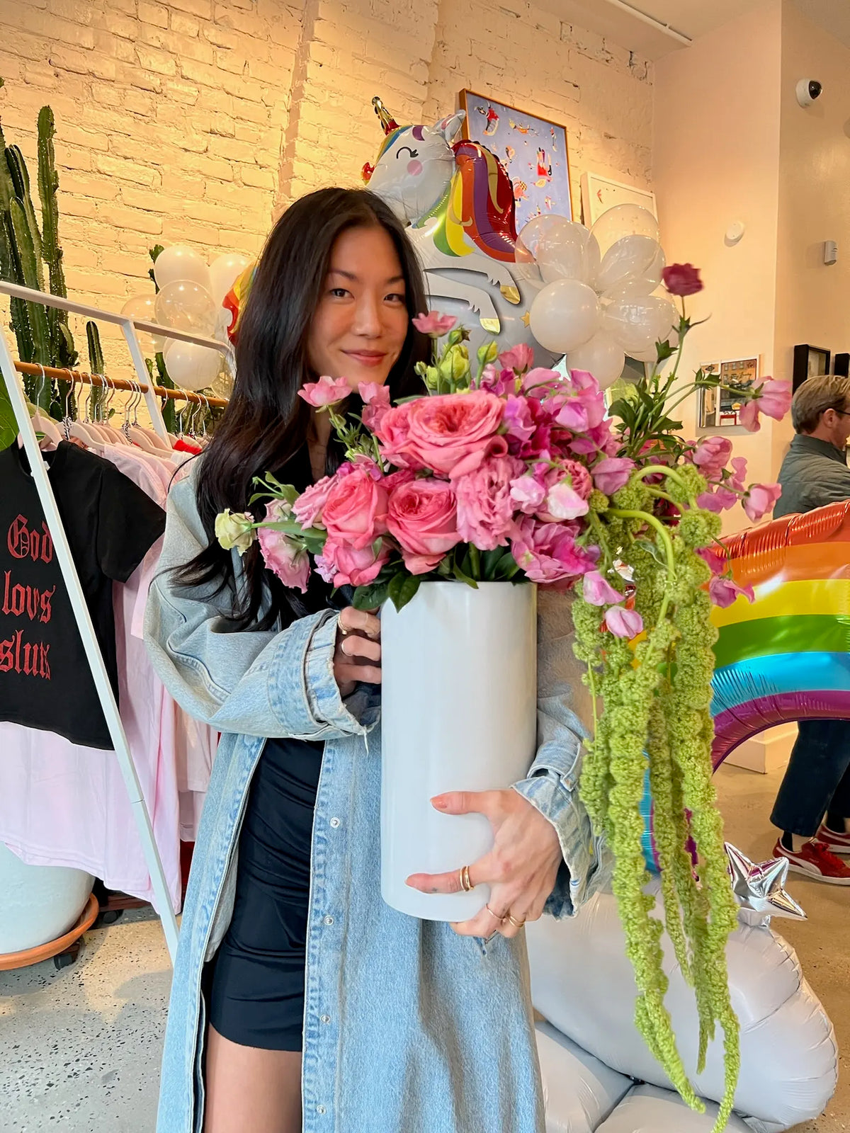 Owner of Mighty Lucky holding flowers inside the cannabis dispensary near the Lower East Side in NYC