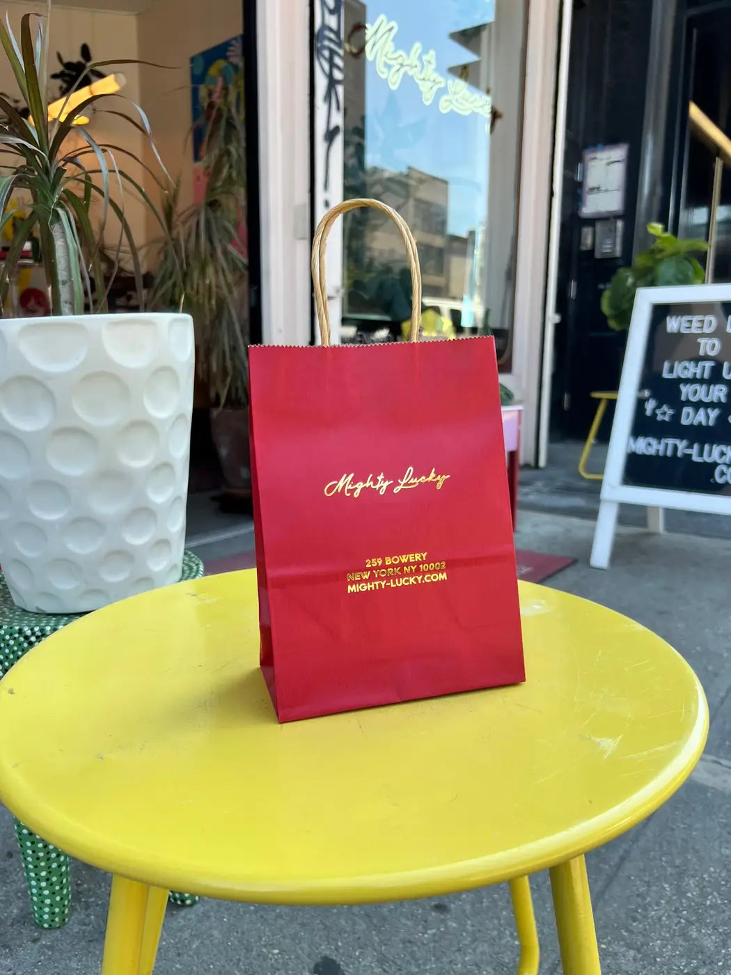 Mighty Lucky branded shopping bag outside the licensed cannabis dispensary at 259 Bowery, New York